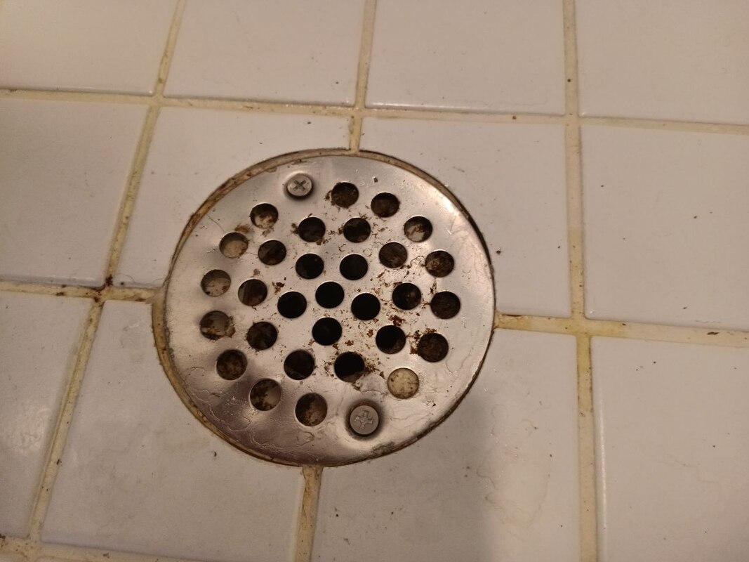 How to remove a shower drain cover